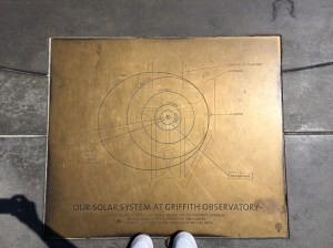 At the foot of the entrance stairs